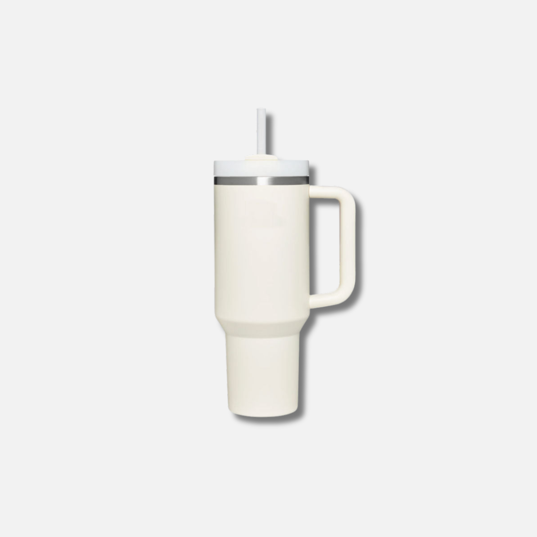 a white coffee cup with a straw sticking out of it