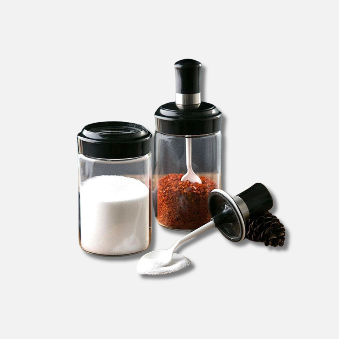 a salt and pepper shaker next to a pepper mill